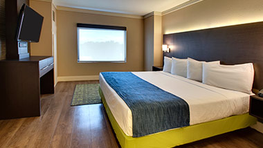 hotel suite with tv and king bed
