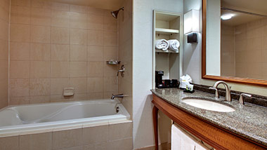 hotel bathroom with bathtub and vanity