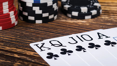 Stacks of poker chips and all the face cards in the suite of spades.