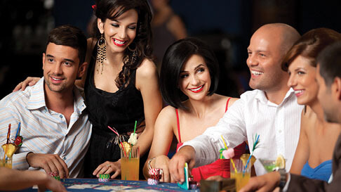 Two men and three women play a hand of poker at Hollywood Casino in St. Louis, Missouri.