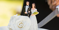 A wedding cake topper showing the bride and groom.