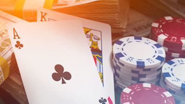 poker hand with chips and cash